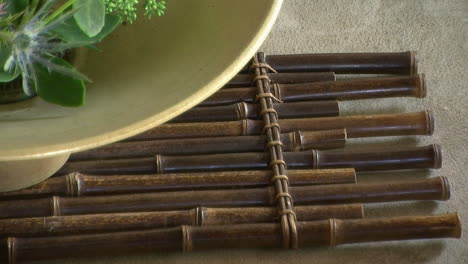 bamboo mat under an ikebana flower arrangement