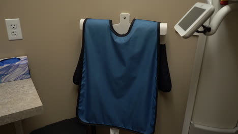 blue lead apron x ray protection vest in dental operatory room and dental clinic