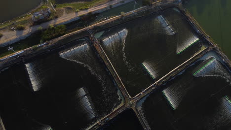 an aerial shot made over a shrimp farm aerators, that are spinning