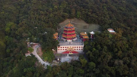 Backwards-Drone-Shot-of-a-Red-Temple-In-Hong-Kong