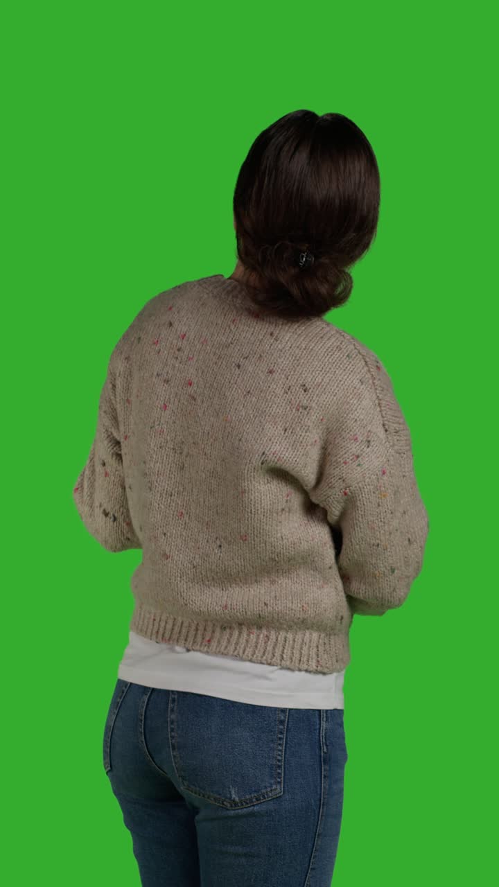 Vertical video: Back view close up of adult showing something aside