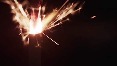 video of close up of sparkler and copy space on black background