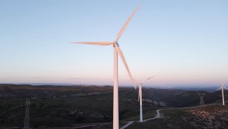 Close-up-on-wind-turbines-in-sunset-sunlight,-renewable-energy-concept