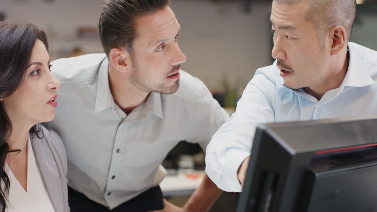 Creative business team meeting happy people working in modern office late at night discussing strategy using computer touch screen in diverse gender group