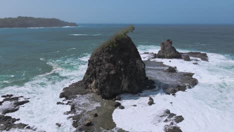 Watu-Lumbung-beach-with-powerful-waves,-aerial-drone-view