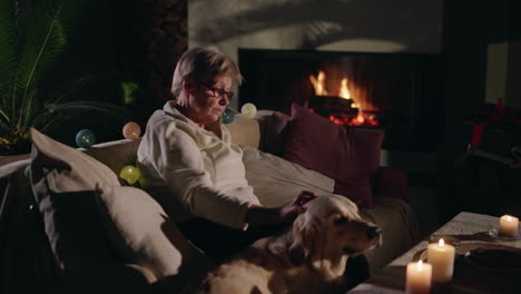 elderly woman and dog by the fireplace