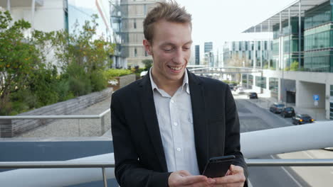 man receiving news on phone, looking surprised, saluting