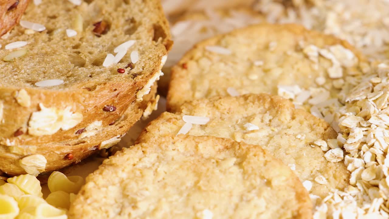 Whole wheat bread, tagliatelle, and conchiglie pasta arranged in a warm, inviting setting with soft lighting