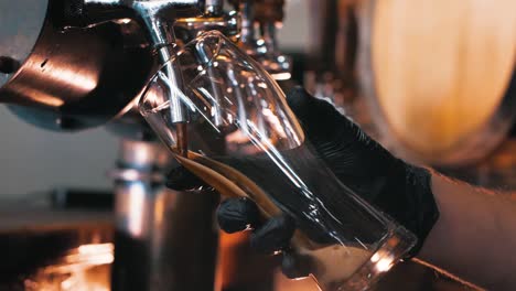 Close-up-of-dark-stout-beer-being-poured-into-a-glass