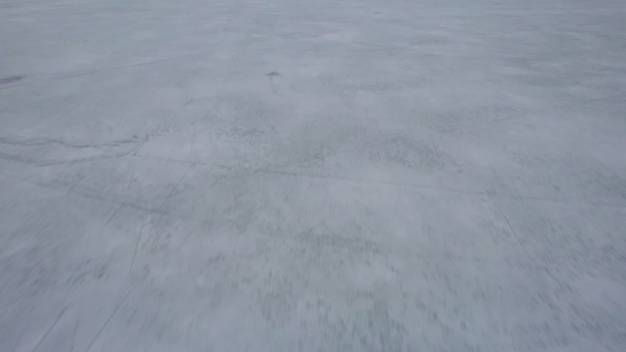 Flying above a frozen mountain lake
