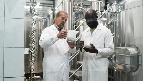 men holding product in container