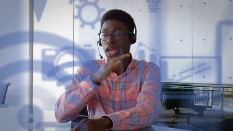 animation of digital icons over businessman using phone headset