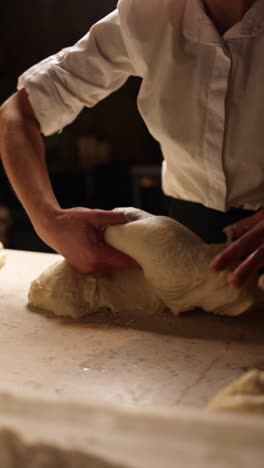 baker kneading dough