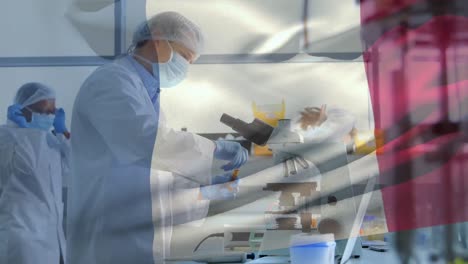 animation of french flag with healthcare worker in background during coronavirus pandemic