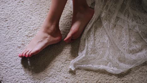 close-up of women's legs with a beautiful manicure. the girl lay down in the bedroom on the floor