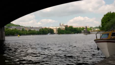 prague river view from under a bridge