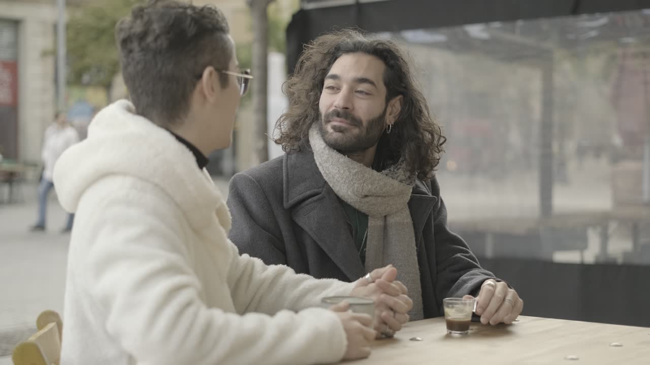 Two people enjoying coffee at an outdoor cafe