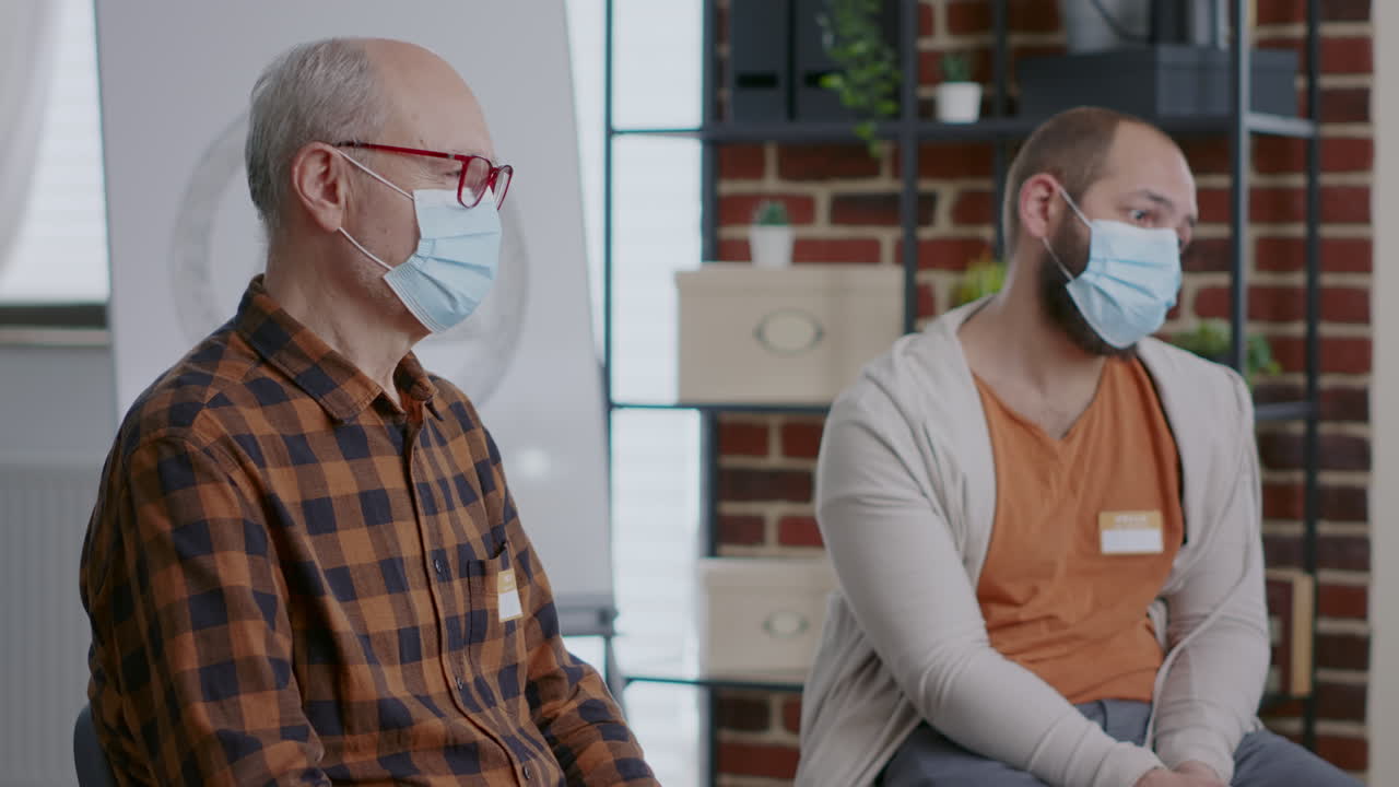Close up of patients with addiction wearing face mask at aa group meeting