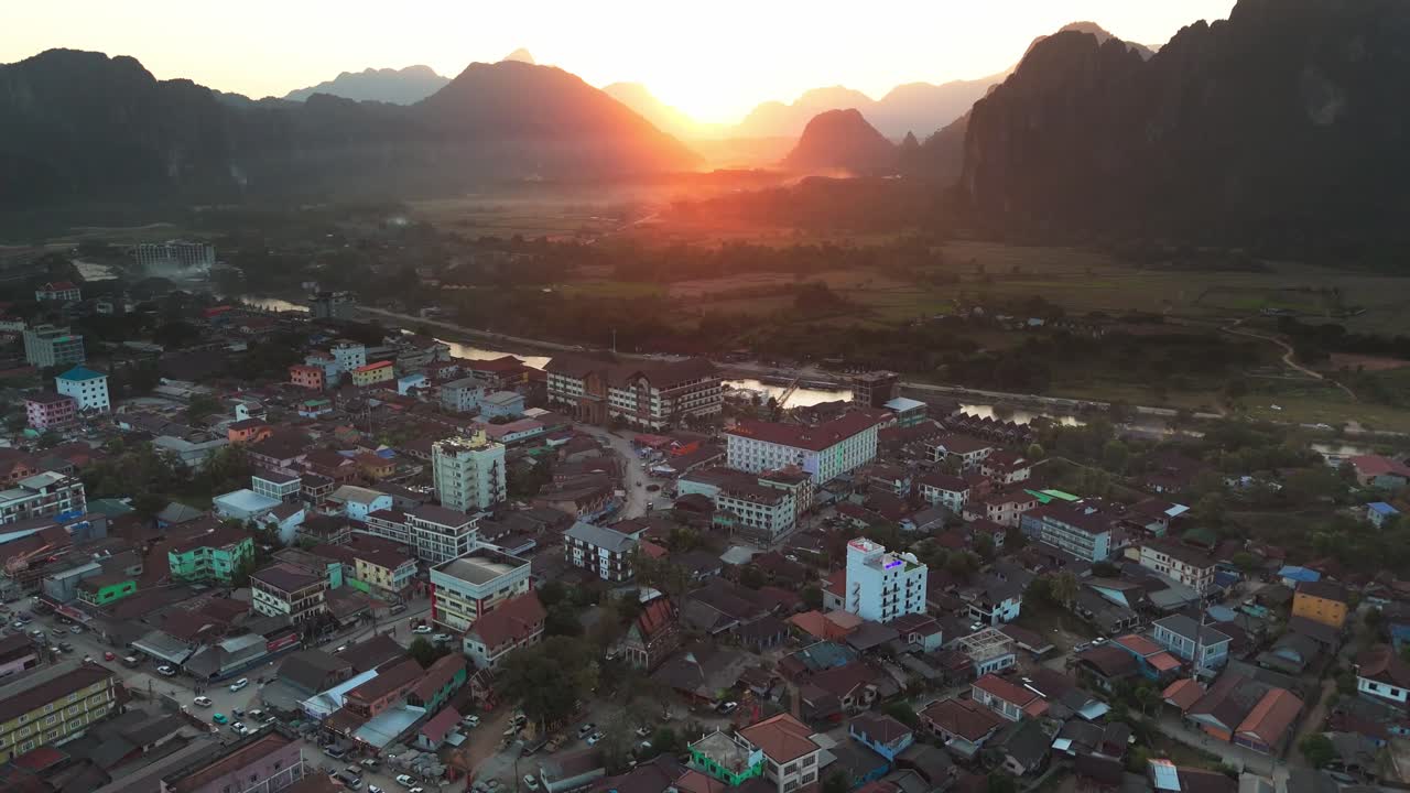 Aerial sunset view Vang Vieng north of Vientiane, on the Nam Song River in Laos drone fly above scenic town tourist destination