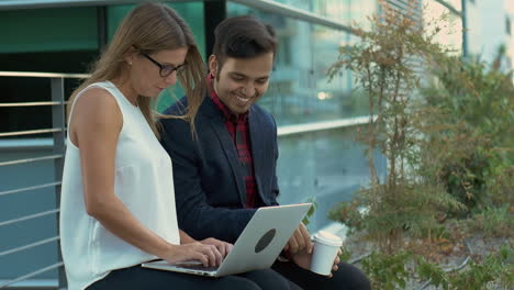 young business people using laptop outdoor