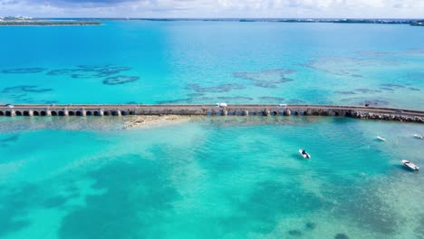 Aerial-hyperlapse-of-car-bridge-over-turquoise-water-on-tropical-island