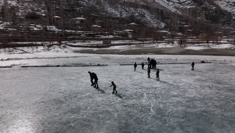 Many-people-go-outside-on-the-frozen-lake-to-ice-skate