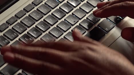 Close up of female hands typing on a laptop keyboard