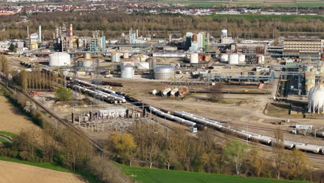 aerial shot of alsachemie rail station with trains amid industrial background, daylight