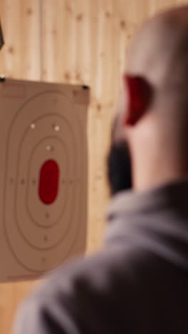 Vertical video Shooting range safety officer shows how to reload pistol, following regulations