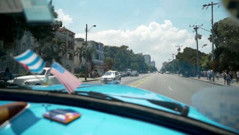 cuban street scene from a classic car