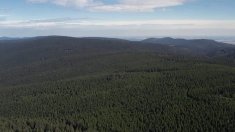 pan up, reveal lush beautiful forest covered mountains near prague, czech republic, aerial