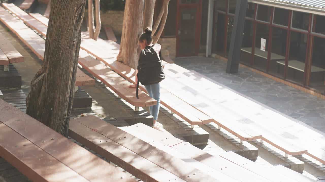 Walking with backpack, student heading to school in outdoor campus area
