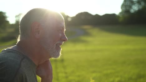 Slow-motion-sunny-scene-of-man-sneezing-showing-aerosol-using-water-hose