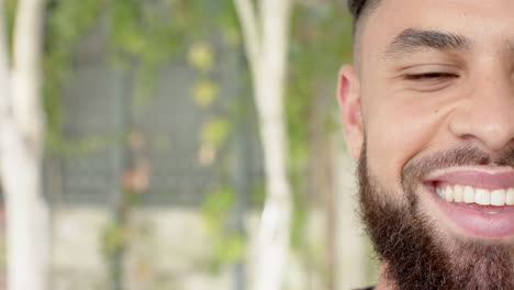 smiling young man with beard enjoying outdoor time with diverse friends, copy space