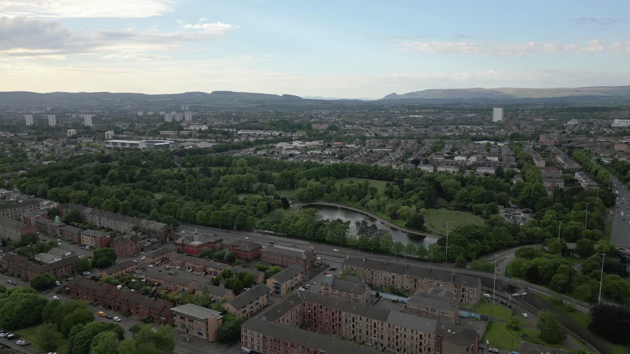 Wide aerial orbit around Victoria Park at West End of Glasgow in golden hour, Glasgow, Scotland, UK