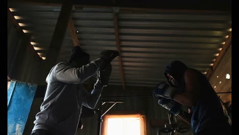 african american male boxer practicing boxing with trainer in gym 4k