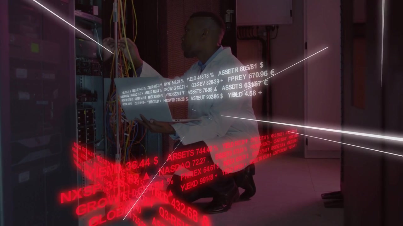 IT tech kneeling server rack checking laptop, routing cables while white ticker red band scrolling