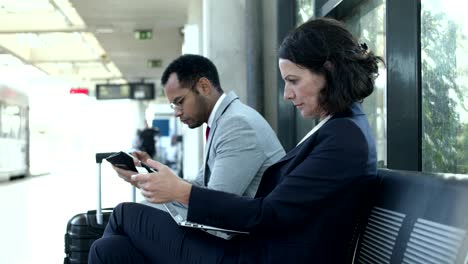 focused business people with digital devices