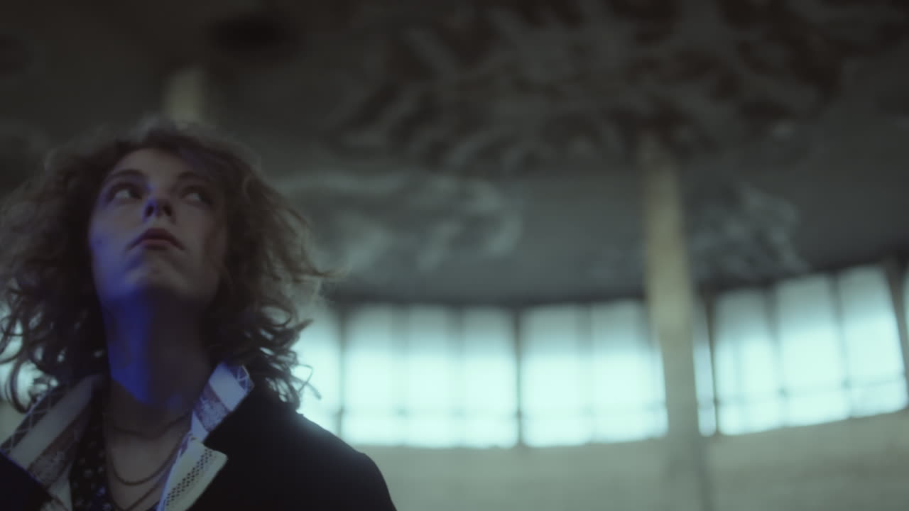Person looking up in an old, abandoned building