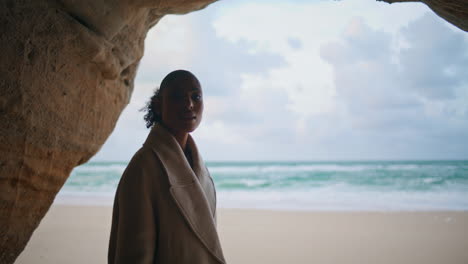 woman silhouette ocean cave at cloudy sky. beautiful serene model exploring