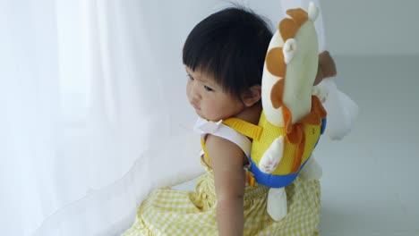 a sweet moment of a baby girl exploring her surroundings with care and curiosity.