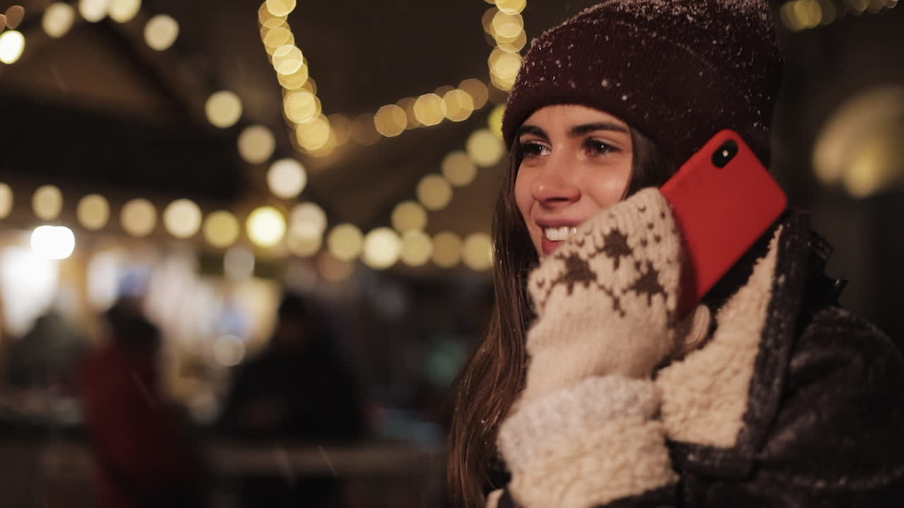 Woman talking on the phone outdoors in winter