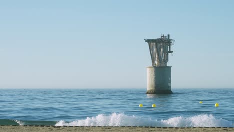 Tower-of-the-old-mineral-loading-dock-in-Playa-del-Cable,-Marbella,-Spain