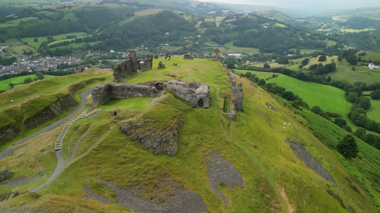 Ancient Castle Ruins on a Hilltop in a Green Valley