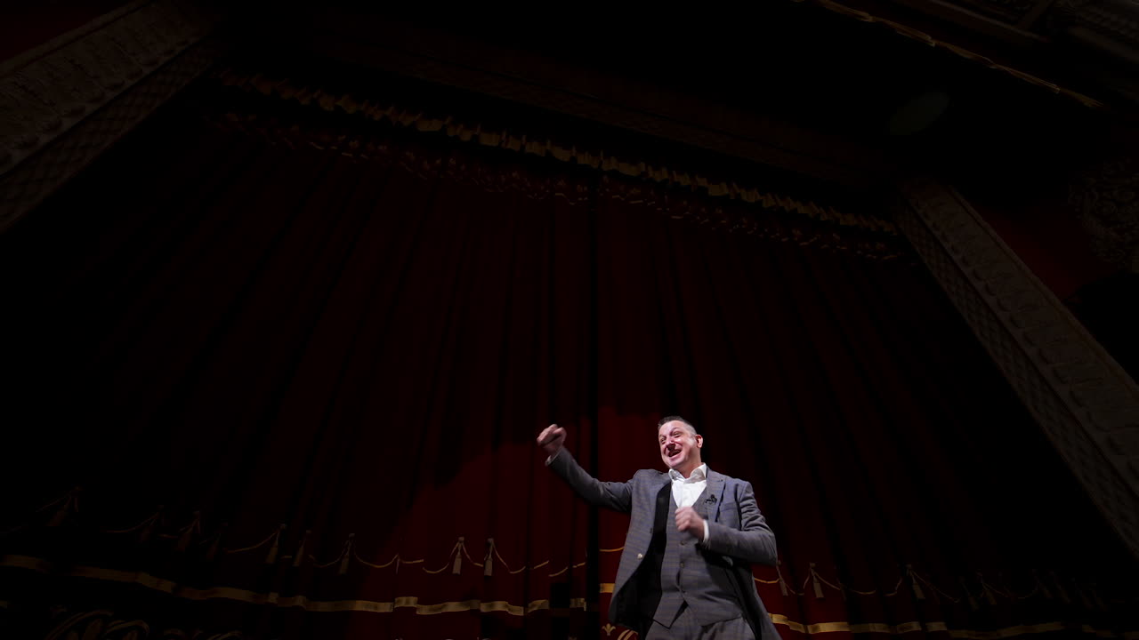 Businessman in theater says about politics and finance. Motivational Speaker.