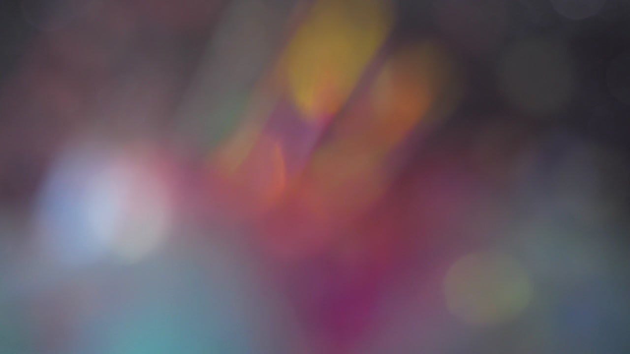 Trendy neon colors festive sparkling defocused lights. Blue, yellow and purple bokeh 4K. Perfect stylish abstract overlay footage. Christmas New Year blinking flashing colorful background.