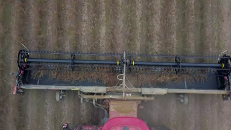 top down up-close view of combine tractor harvesting soybeans on farm showing how a combine works