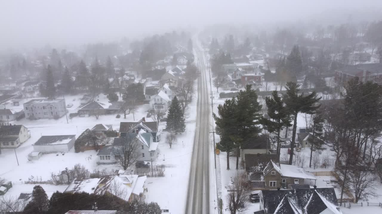 Tilt down during winter with heavy snowfall in a neighborhood in the city of Orford, Québec, Canada.