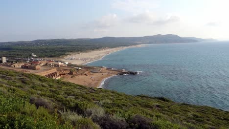 Mediterranean-see,-shore,-beach-and-harbour-from-cliffs-in-Sardaigna