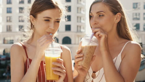 two friends enjoying drinks outdoors